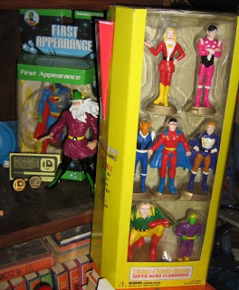  ABOVE: The Legion PVC figures came in their own clubhouse-shaped box. I like how the Colossal Boy figure is bigger than the others. To their left is Mordru and the Composite Superman, along with two plastic flight rings and a Legion membership card.